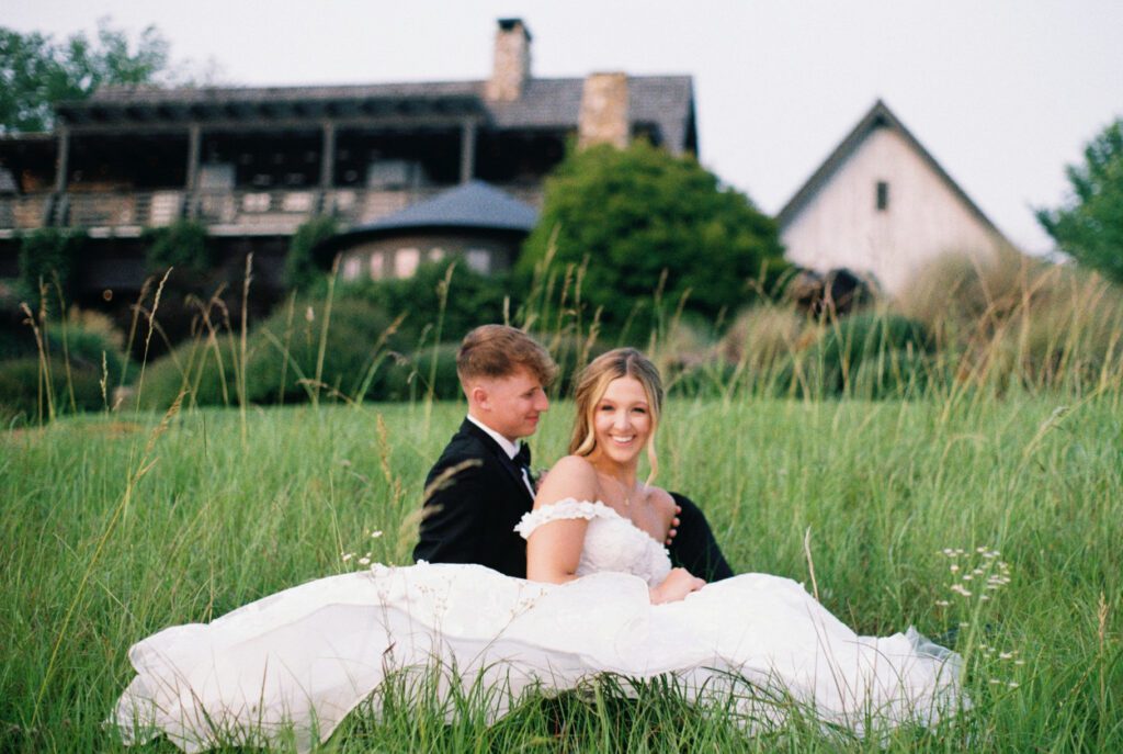 couple sitting in front of their wedding venue