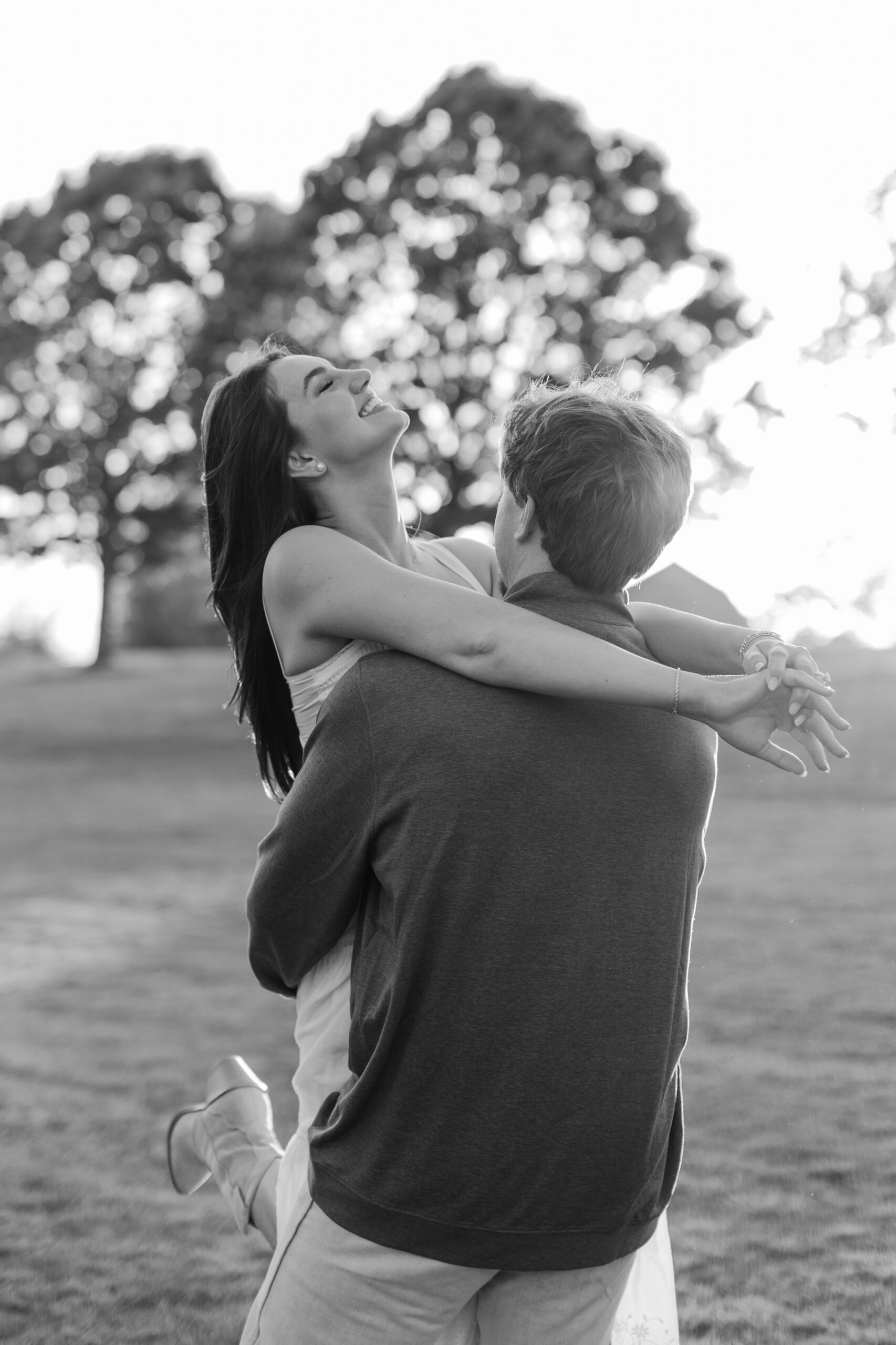 engagement session where the woman is being lifted