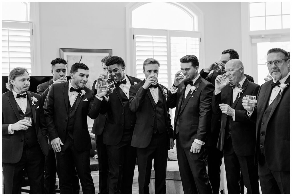 Groom and groomsmen drinking whiskey at Sanctuary Golf Club