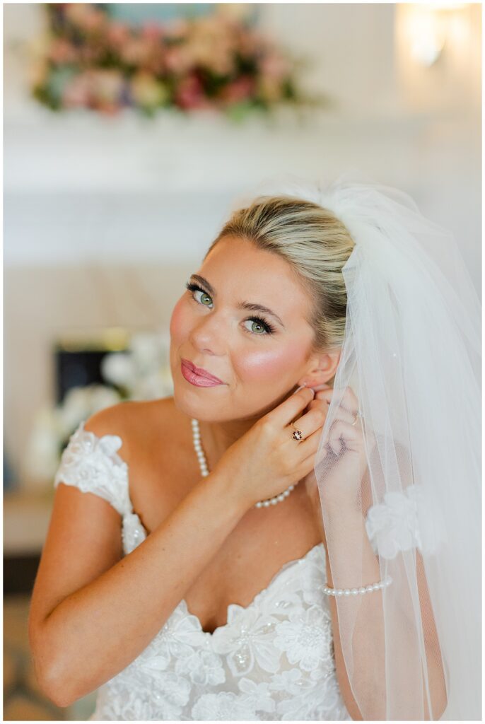Bride putting in her earrings at Sanctuary Golf Club