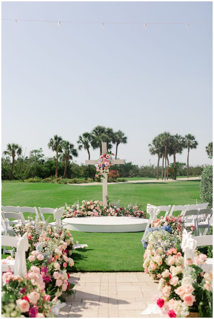 Ceremony set up with lots of pink florals at Sanctuary Golf Club