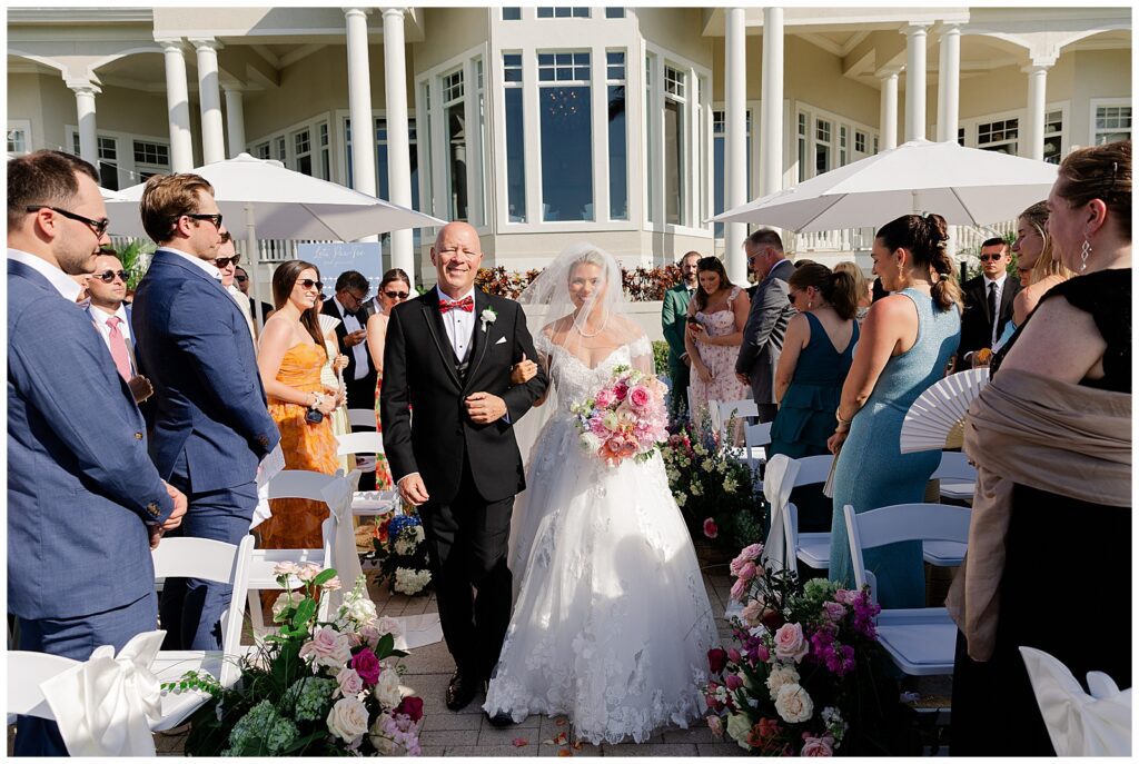 Bride and her dad walking down the Aisle at Sanctuary Golf Club