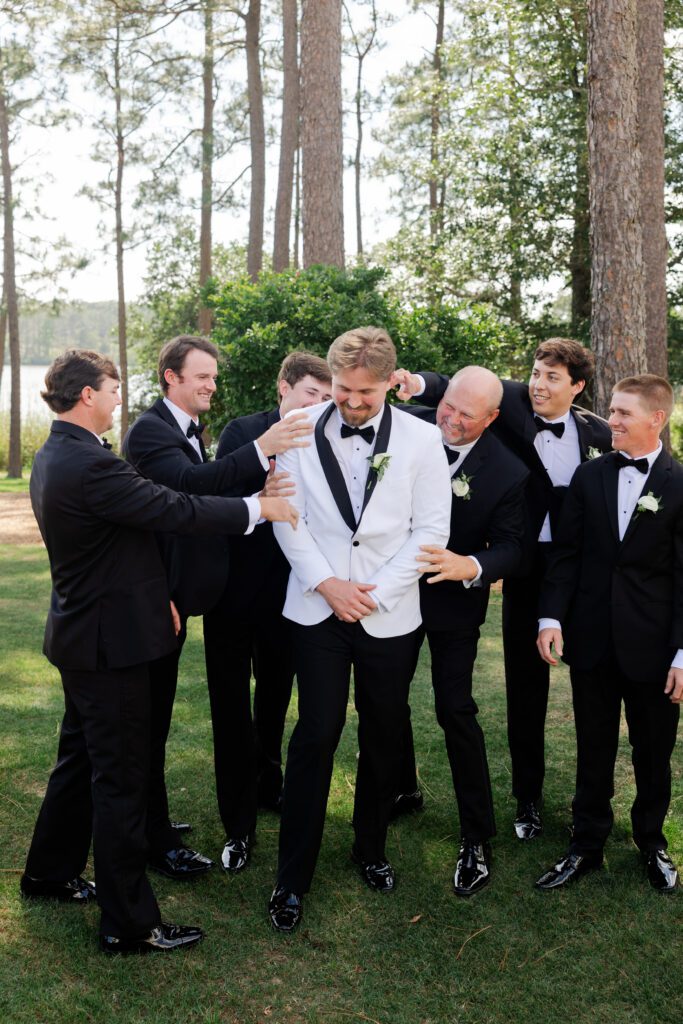 Groomsmen gather around Lake on the grounds of Steelwood Country Club