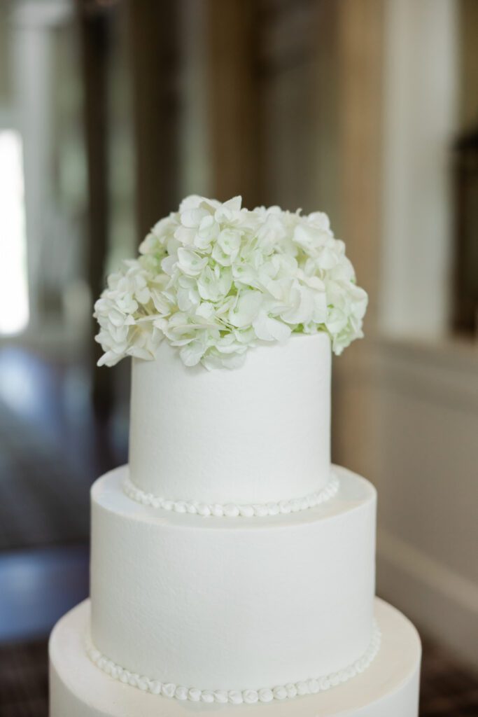 White three-tier wedding cake with hydrangeas at Steelwood Country Club