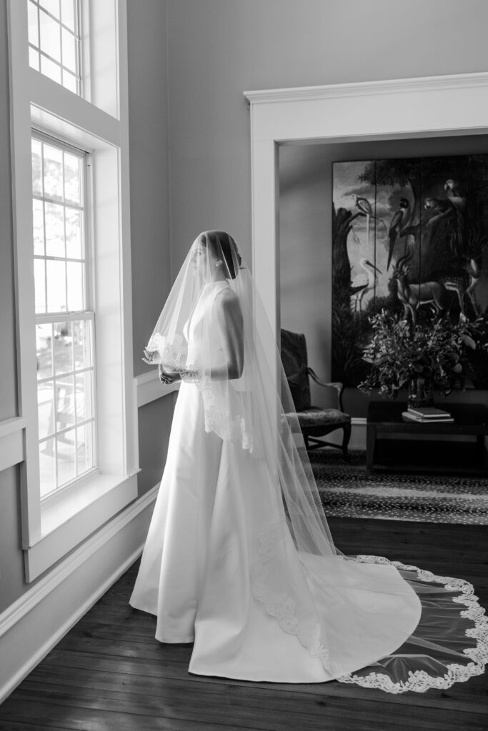 Grace poses in her wedding gown and veil inside Steelwood Country Club