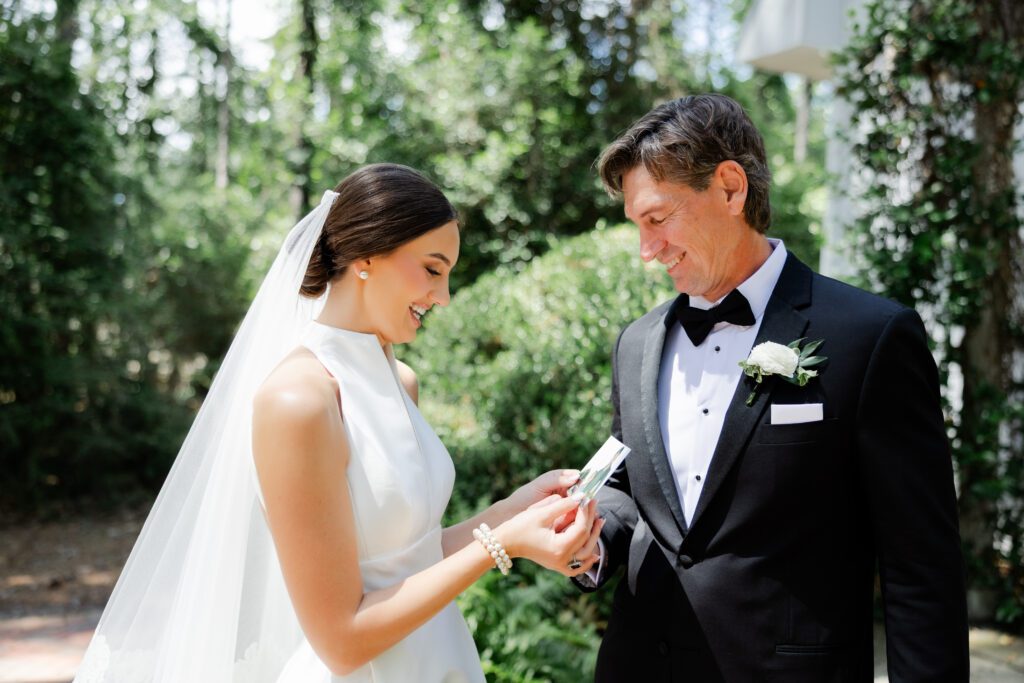 Grace shares a wedding-day moment with her father a black tuxedo at Steelwood Country Club