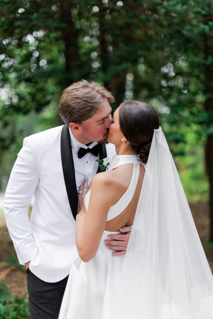 Grace and Lake kiss during their Steelwood Country Club wedding in Loxley, Alabama