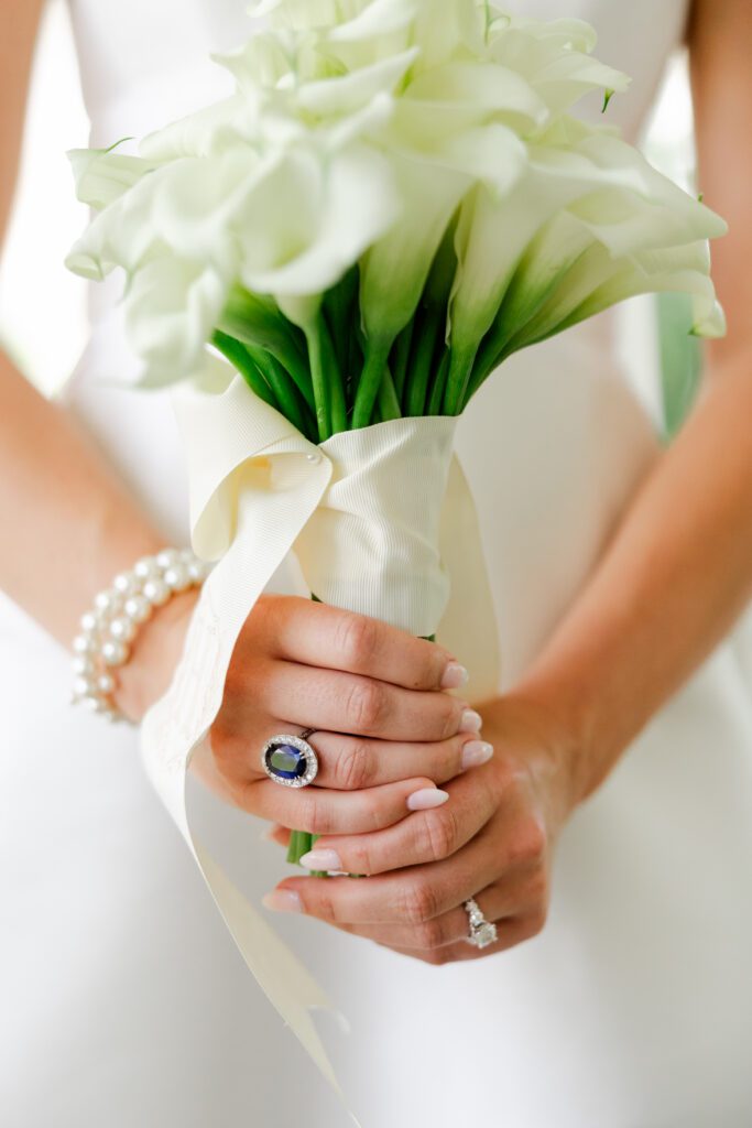 Grace holds a white calla lily bouquet during her Loxley, Alabama wedding