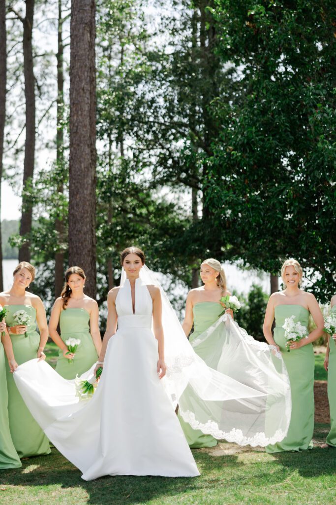 Grace and her bridesmaids pose in sage green dresses at Steelwood Country Club
