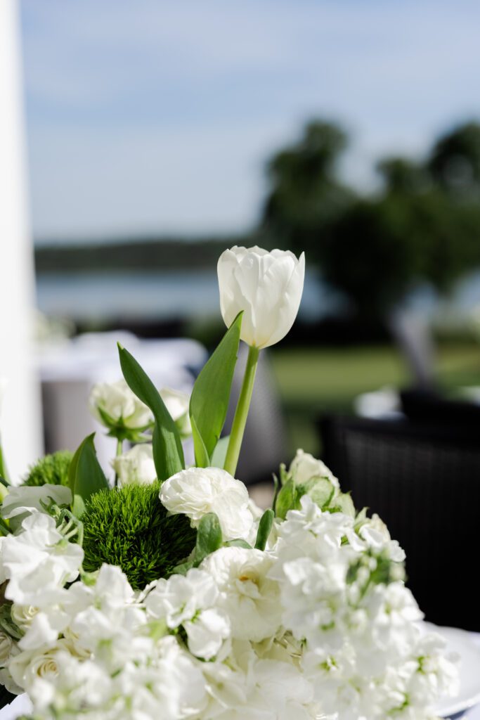 White and green wedding flowers overlooking the water at Steelwood Country Club