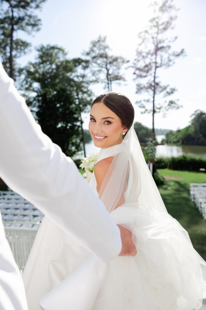 Grace looks toward Lake after their Steelwood Country Club wedding ceremony