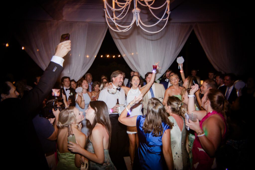 Grace and Lake celebrate on the dance floor with wedding guests