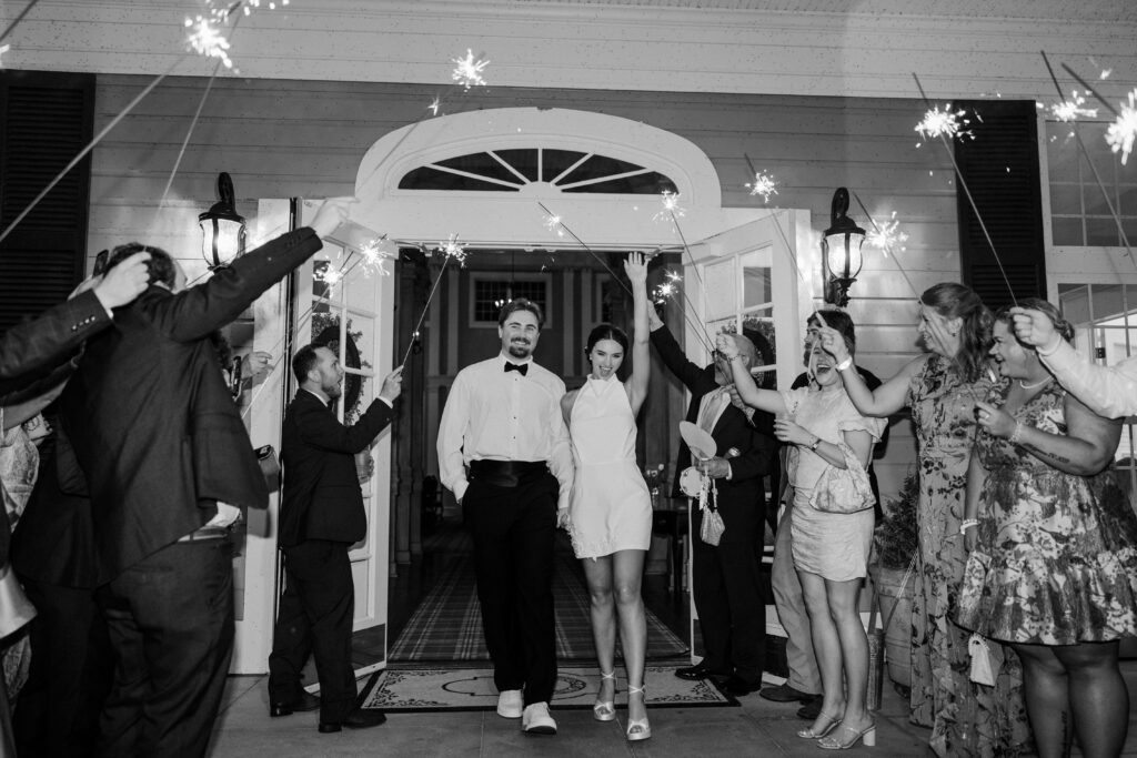 Grace and Lake leave their wedding reception through a sparkler exit