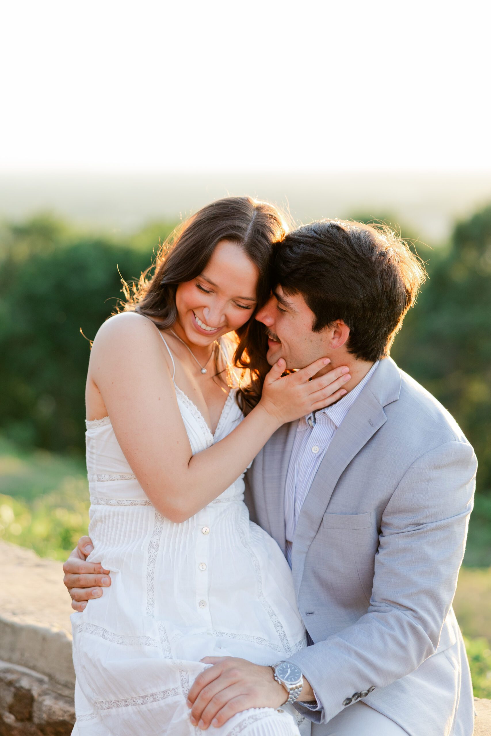 Local Birmingham couple laughing together during their engagement photoshoot at the Birmingham Botanical Gardens.